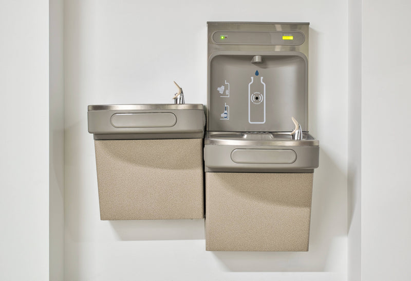 Bottle filling station mounted on a wall with beige panels.